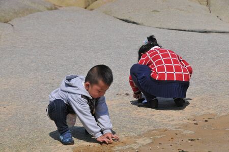 children playing at beachのeditorial素材