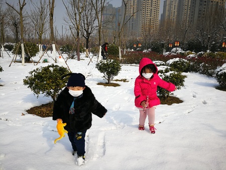 Beautiful snow at park with children playing aroundのeditorial素材