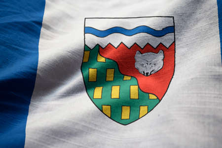 Closeup of Ruffled Northwest Territories Flag, Northwest Territories Flag Blowing in Windの写真素材