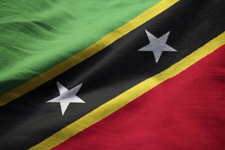 Closeup of Ruffled Saint Kitts and Nevis Flag, Saint Kitts and Nevis Flag Blowing in Windの写真素材