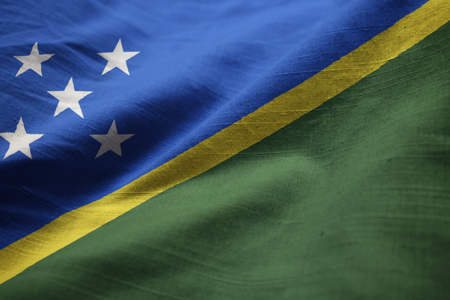 Closeup of Ruffled Solomon Islands Flag, Solomon Islands Flag Blowing in Windの写真素材