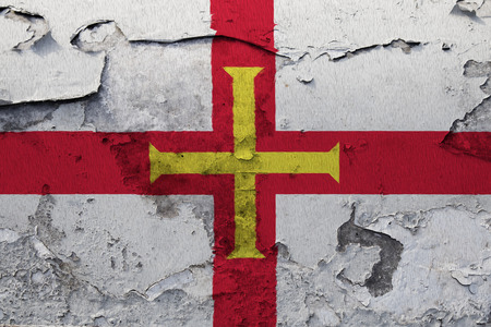 Painted national flag of Guernsey on a concrete wallの写真素材