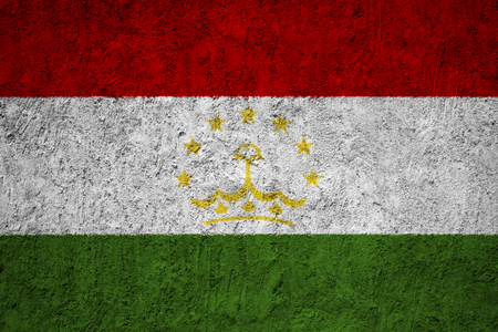 Tajikistan flag on the grunge concrete wallの写真素材