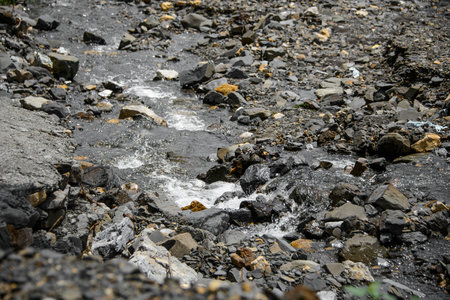 Water flowing over river rocks near mountains in Nathia Gali, Abbottabad, Pakistan.の写真素材