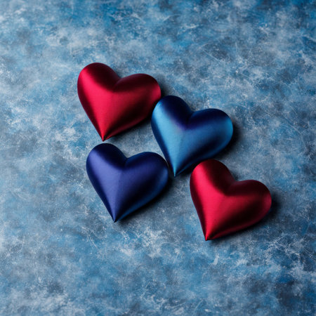 Blue and Red silk hearts on a Blue color backgroundの素材