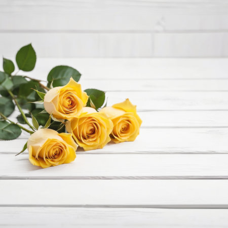 Three Yellow rose flowers over white wood background. Romantic greeting card for Valentine's Day.の素材