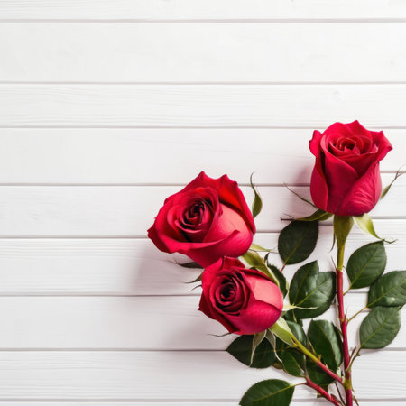Red rose flowers over white wood background. Romantic greeting card for Valentine's Day.の素材