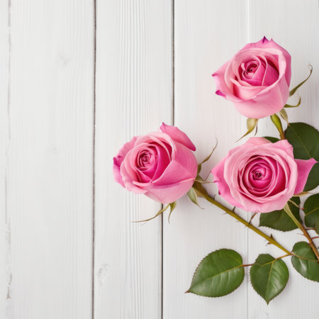 Flowers of pink roses on white wood background. Happy Valentine's Day with this romantic greeting card.の素材