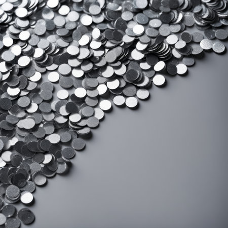 Silver glitter confetti on a gray background. Silver shiny sequins.の素材