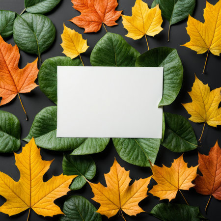 Creative layout made of autumn leaves and blank card on black background. Flat lay, top view, copy spaceの素材