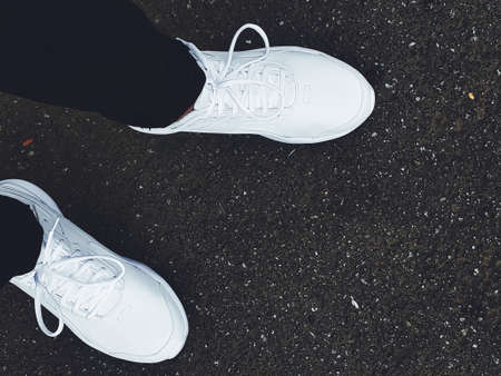 White sneakers on the asphalt. The concept of a healthy lifestyle.の写真素材
