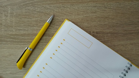 Agenda with pen on wood deskの素材