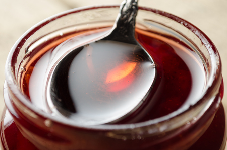 Spoon Dipped into Strawberry Jamの写真素材
