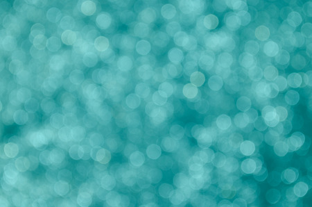 Teal abstract bokeh background.