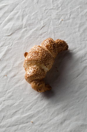 Fresh croissant on a white linen tablecloth.の写真素材
