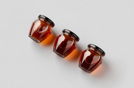 Three honey jars mockup on a grey background.の写真素材