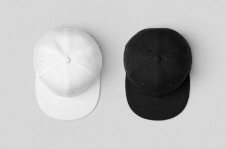 White and black snapback caps mockup, side by side.の写真素材