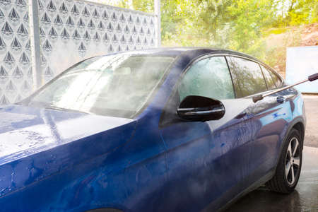 Car Washing. Cleaning Car Using High Pressure Water. Autowashing outdoors.の写真素材