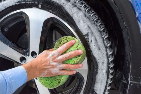 Foam and soap on the car wheel. Washing a car.の写真素材