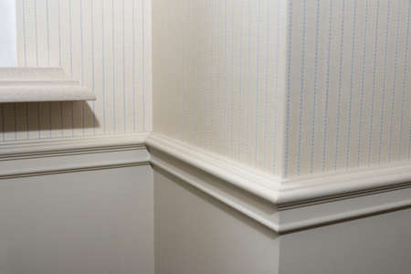Ceiling moldings in the interior, detail of a angular wall skirting.の写真素材