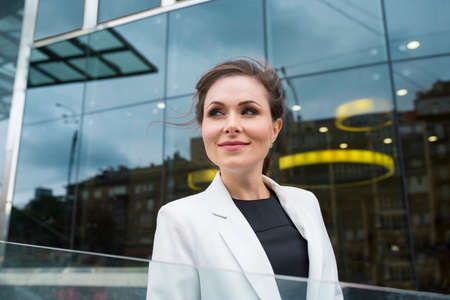 A portrait of happy beautiful businesswoman smiling outdoors. A company employee.