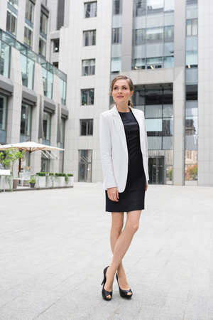 A young successful woman of fashion model type outdoors.の写真素材
