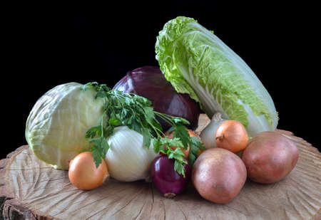 Fresh organic vegetables, cabbage, onions, potato, green onions, on a wooden background.の写真素材