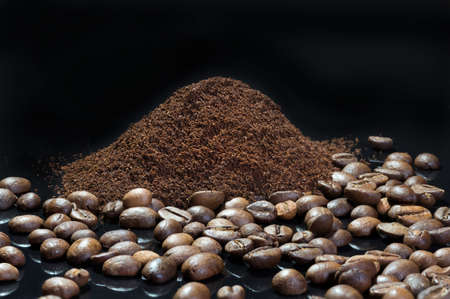 Beautiful seeds of coffee close up on a black background. ground coffeeの写真素材