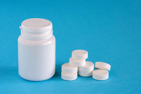 Medicine. Pills near the box on a blue background, copy space, assorted pharmaceuticalの写真素材