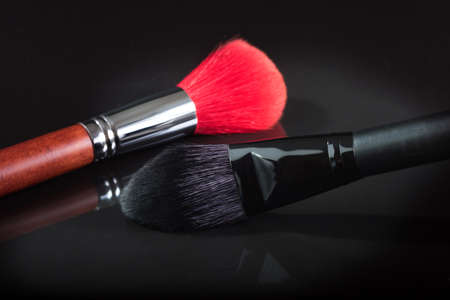 Black and red brush for a make-up on a black background. close up.の写真素材