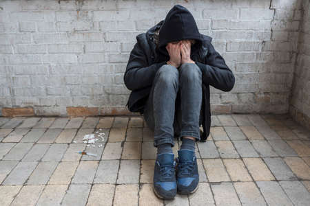 Addict and drugs in an abandoned house. International Drug Abuse Day. Addiction concept.の写真素材