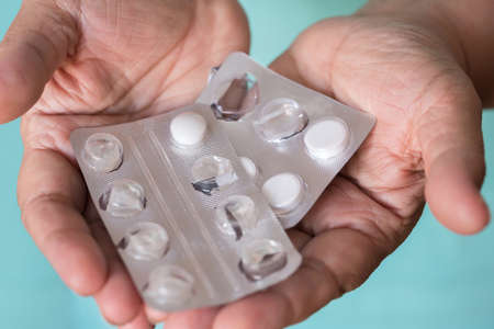 Medical pills in the hands of an elderly man. Health care of elderly people