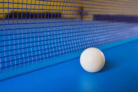 White table tennis ball on blue table with net. Table tennisの写真素材