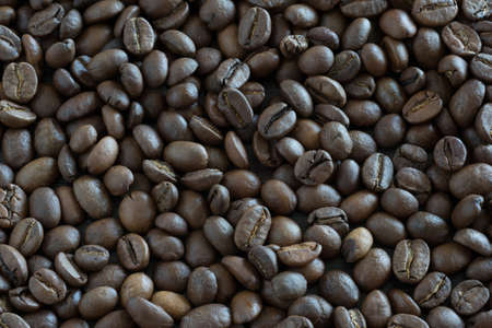 Coffee beans by close-up. Background from coffee grains.