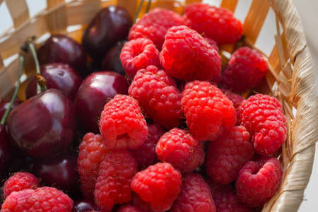 Raspberries and cherries close-upの写真素材