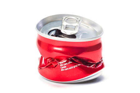 A red empty broken aluminum can at the white background, a close up.