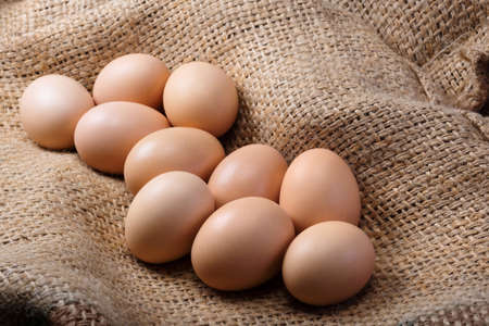 Fresh eggs of a farm on burlap close up. Healthy food, natural protein