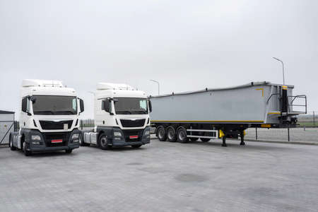 Trucks and trailer in the parking lot. Loading in an industrial park. Logistic and transport...