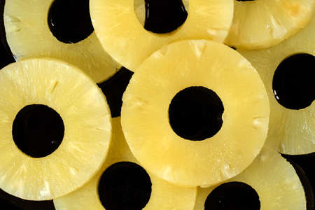 Pineapple slices on a black background close-up. View from above.の写真素材