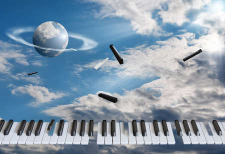 Flying piano keys are getting blown apart. Against the background of the blue sky, in the white cloudsの写真素材