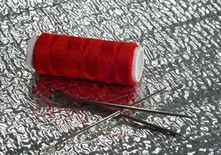 Thread on a silver backgroundの写真素材