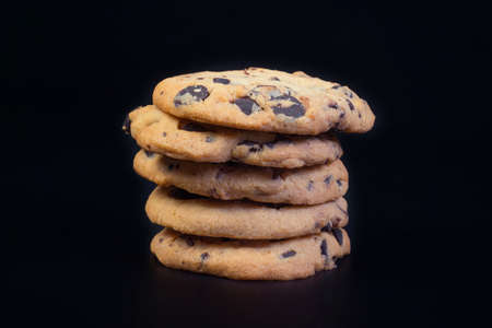 A close-up of cookies at the black background. Homemade cookies at the black background.