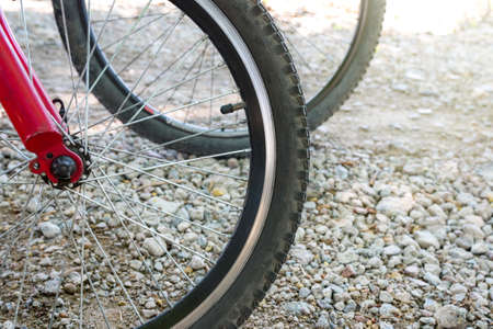Bicycle wheel and dirt road close-up. The concept of a sports lifestyle.