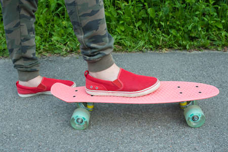 Plastic skate and legs closeup. Healthy lifestyle.