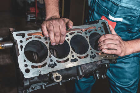 Auto mechanic repairing a car engine. Repair service in the garage.