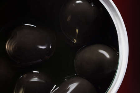 Black olives in jar. Top view, backgroundの写真素材