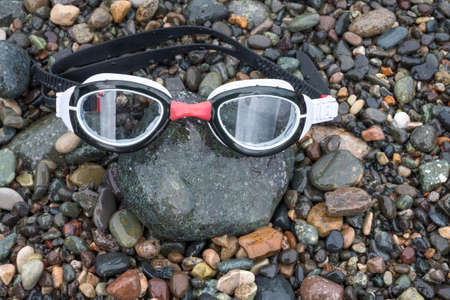 Glasses for submarine swimming, lie on pebbleの写真素材