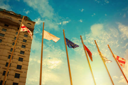 Flags of the countries, the Georgia, Turkey, the European Union, in sunny day.