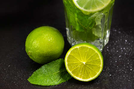Fresh green mint and lime close-up on a dark background.の写真素材