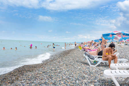 Batumi, Georgia - August 07, 2018: People are ashore sea in Batumi. Black sea. pebbles sea beachのeditorial素材